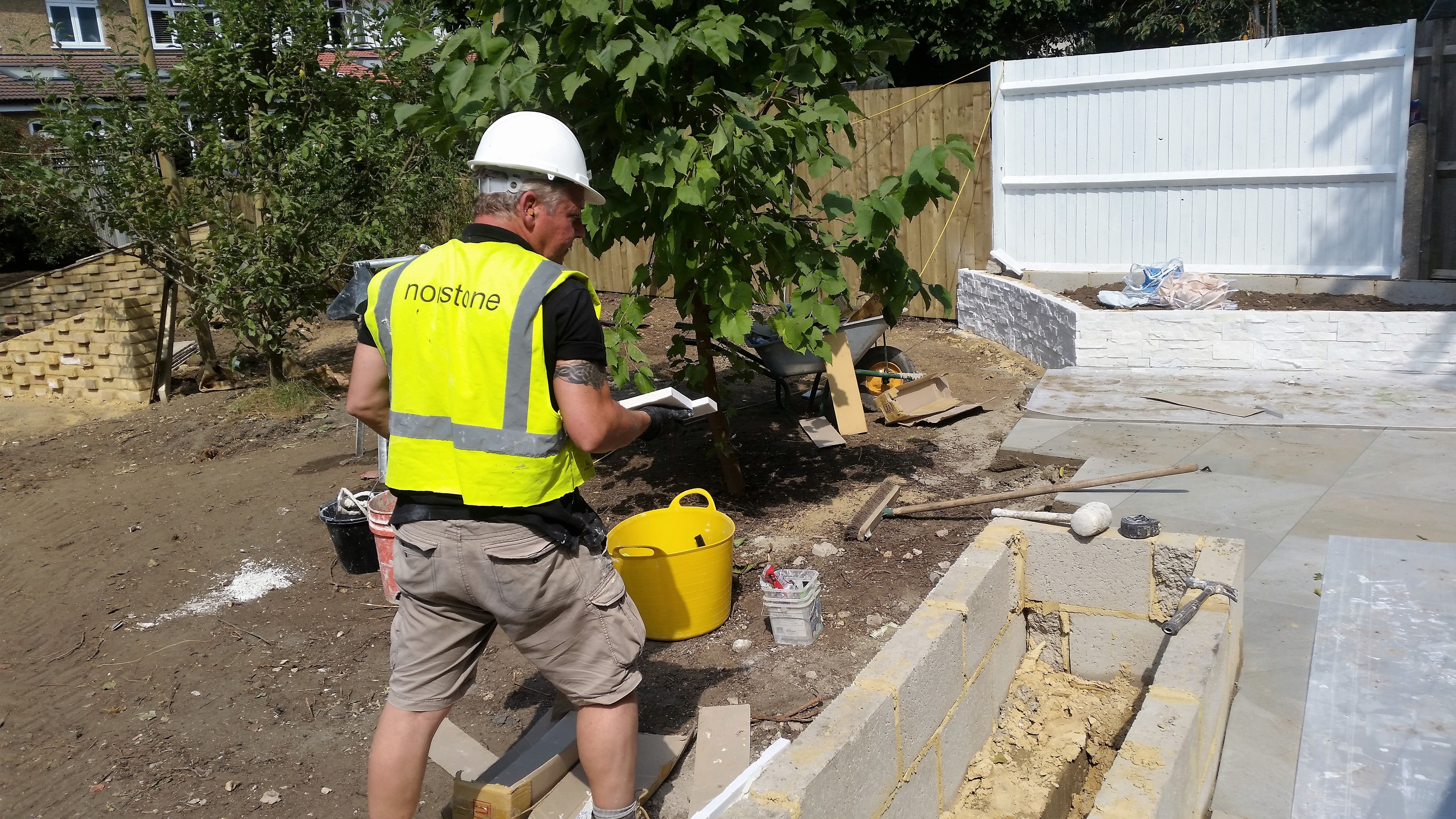 Norstone White Rock Panels being installed on an exterior garden wall and cleaned up post installation without the need for acid.